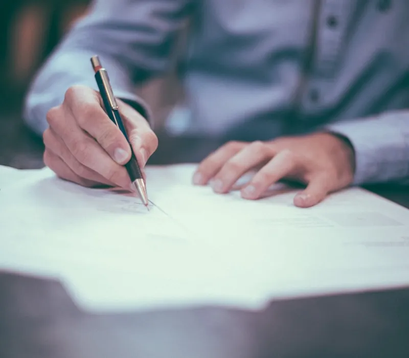 Experienced insurance agent reviewing policy documents with client